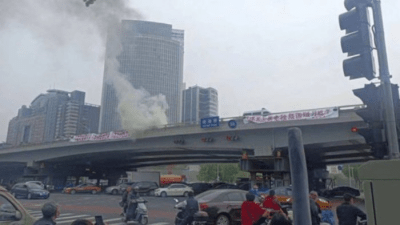 'Bridge man' registering his protest with smoke on a Beijing flyover, China, 2022